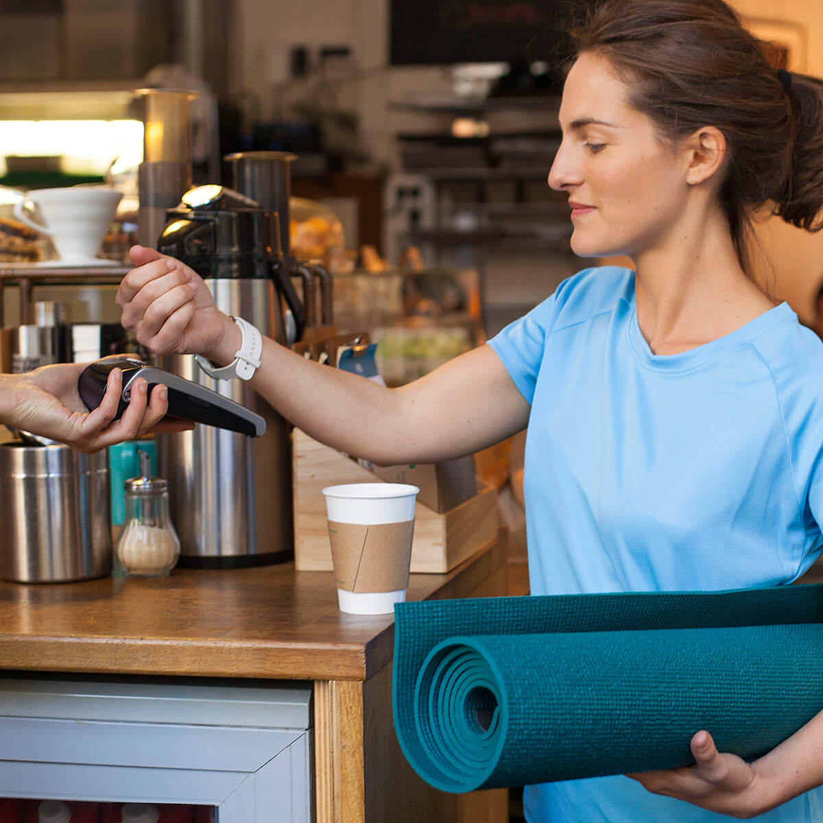 Женщина на стадионе держит в руках телефон