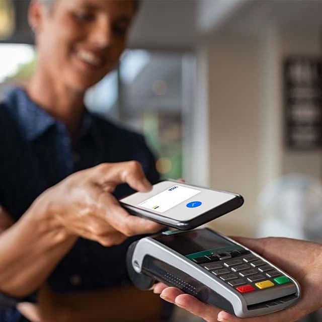 A man paying contactless with his smartphone