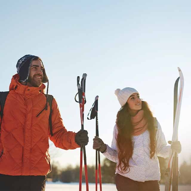 A man and a woman with ski